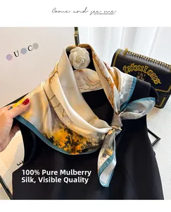Detail of 100% mulberry silk scarf with mountain print and elegant camellia brooch