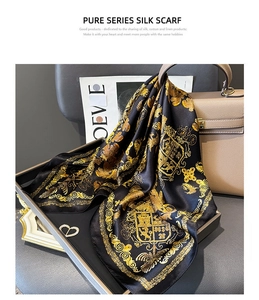 Detail of silk scarf with baroque pattern draped over a beige leather handbag
