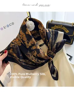 Detail view of 100% silk square scarf with golden baroque pattern and fine rolled edges