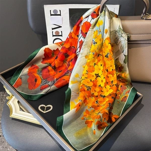 Silk-like floral scarf in orange and yellow with a heart rhinestone brooch accessory