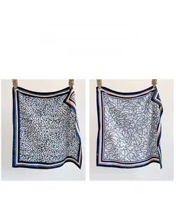 Detail of double-sided silk scarf featuring leopard print and elegant chain patterns