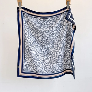 Square silk scarf featuring leopard print, golden chains, and anchor patterns in navy blue
