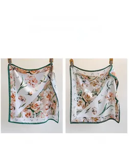 Detail of double-sided vintage floral silk scarf featuring pink peony and butterfly border