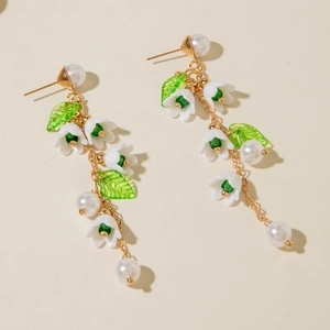 Detail of long lily of the valley tassel earrings with white resin petals and pearls