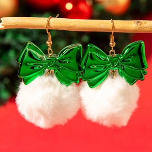 Detail of Christmas bow earrings with green metallic ribbon and white fluffy pom pom