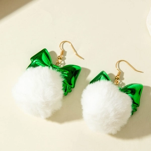 Detail of Christmas bow earrings with green metallic finish and soft white faux fur poms