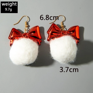 Detailed view of red bow earrings with white pom-poms measuring 6.8cm in length