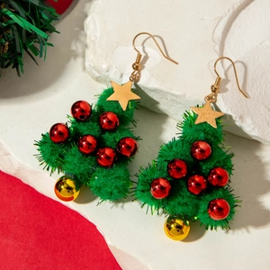 Detail of Christmas tree earrings with green plush pom-pom and gold star toppers