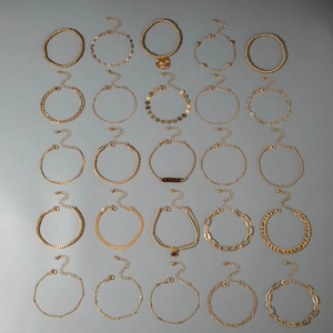 Flat lay of 25 assorted gold-plated fashion bracelets featuring varied chain link designs