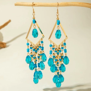 Close-up of Bohemian long tassel earrings with blue beads and teardrop crystals