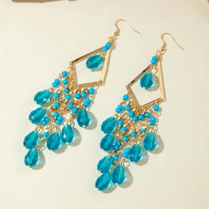 Close-up of Bohemian long tassel earrings with gold diamond frame and blue glass beads