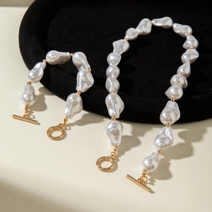 Detailed macro shot of baroque pearl necklace set with vintage gold OT toggle clasp