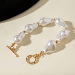 Detailed view of baroque pearl necklace with gold beads and elegant OT buckle closure