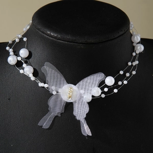 Elegant multi-strand pearl necklace featuring a large white tulle butterfly pendant