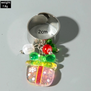 Detailed view of adjustable silver ring with Santa resin pendant and white pearl