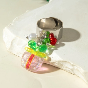 Close-up of wide band ring featuring Christmas charms with pearls and festive pendants