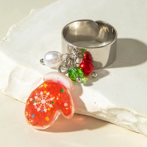 Close-up of silver open ring with resin Santa glove pendant and white faux pearl