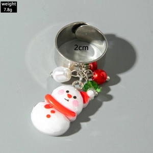 Detailed macro view showing a silver adjustable ring with snowman and pearl charms