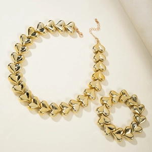 Detail of golden heart link necklace and bracelet set with lobster clasp and chain extender