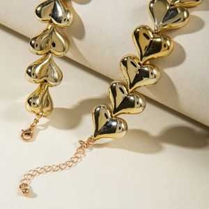 Detail of gold heart link necklace with lobster clasp and adjustable extension chain