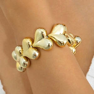 Chunky gold puffed heart chain bracelet for women featuring bold metallic link design