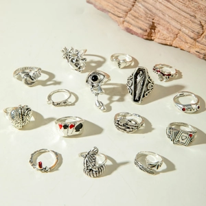 Macro shot of 14pcs vintage gothic skull and snake punk ring set on white background