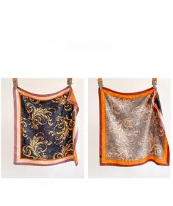 Detail of double-sided silk scarf featuring blue baroque patterns and grey floral design