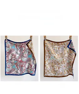 Detailed comparison of double-sided paisley and floral patterns on a luxury silk scarf