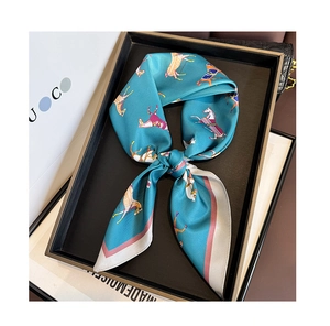 Close-up of silk neck scarf with horse print tied in a bow on a luxury display