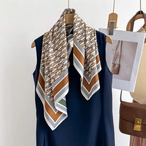Elegant silk scarf with golden chain patterns on creamy background for business wear