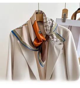 Gros plan d'un foulard élégant en soie avec motifs géométriques et bordure bleue