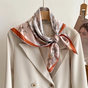 Elegant 70cm twill silk scarf with abstract floral print styled on a beige blazer