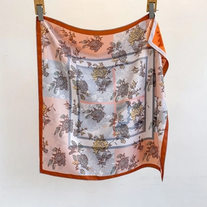 Retro silk scarf featuring orange and pink floral prints and polka dot patterns