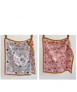 Detail of double-sided silk scarf featuring floral patterns and contrast colors