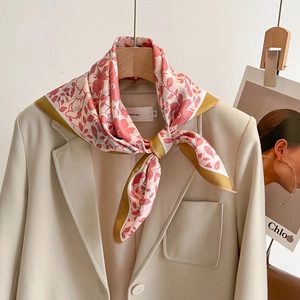 Pink floral silk square scarf with gold trim paired with a beige blazer for women