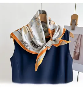 Close-up of floral twill silk scarf draped on a wooden hanger showing retro flower prints