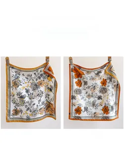 Detail of floral silk scarf showing double-sided contrast colors and bird print