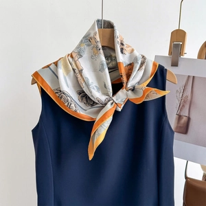 Floral square silk scarf in warm orange and beige with elegant flower patterns