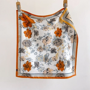 Elegant square silk scarf with orange floral and bird prints on a white background