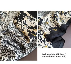 Detail of silk-like printed scarf showing black and white texture with yellow floral accent