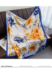 Détail de foulard en satin 90x90cm à motifs fleurs bleu et orange sur fond en cuir