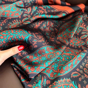 Paisley pattern silk scarf for summer beach wear featuring orange and turquoise motifs