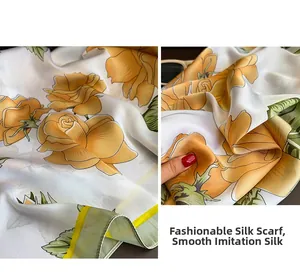 Détail d'un foulard en satin ivoire avec imprimé rose jaune et bordures vertes élégantes
