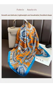 Detail of silk-like paisley scarf in orange and blue draped over a handbag