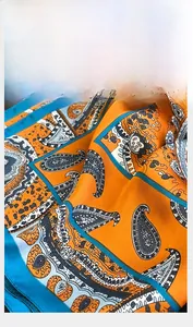 Macro shot showing the fine edge stitching on the paisley silk-feel square scarf