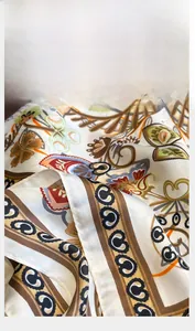 Macro detail of the high-quality silk scarf showing precision stitching and floral print