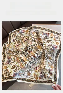 Detail of vintage paisley print silk scarf showing intricate patterns on leather background