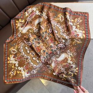 Detail of vintage paisley pattern on a large silk-like square scarf for women