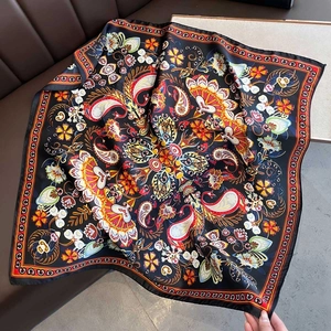 Detailed texture of black paisley silk scarf with vibrant floral and mandala patterns