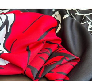 Macro shot of twill weave fabric texture with vintage red and black abstract pattern